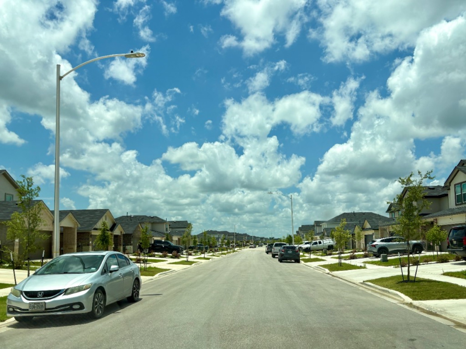 A fully developed street inside Whisper South with homes on both sides